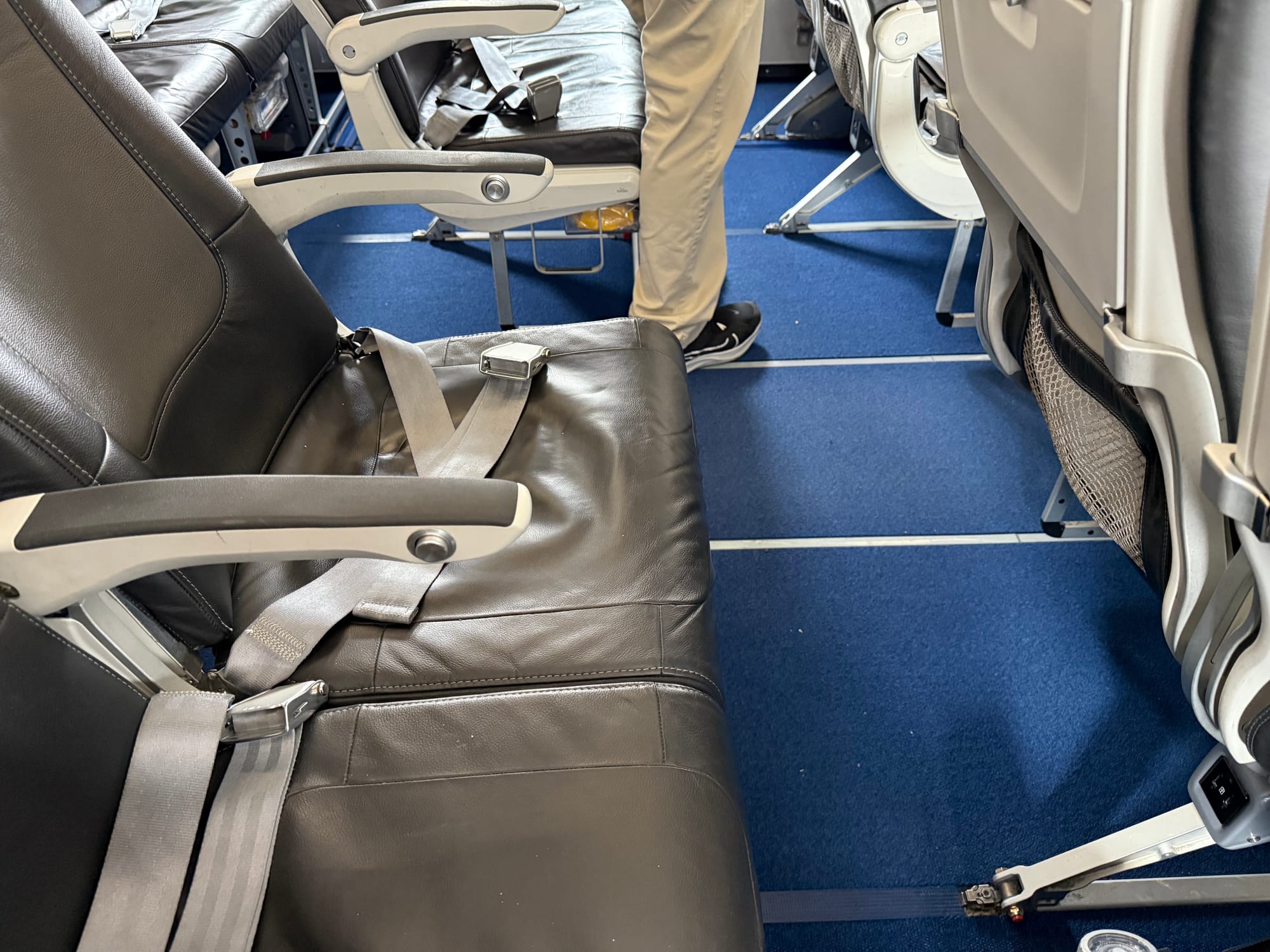 Closeup on the legroom, which looks generous for economy — around 33" or so, I'd estimate.