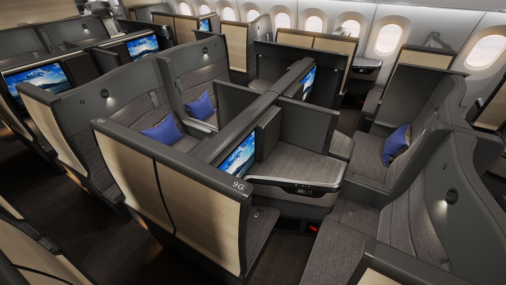 Interior, business class cabin, a forward-backwards suite in grey with light wood.