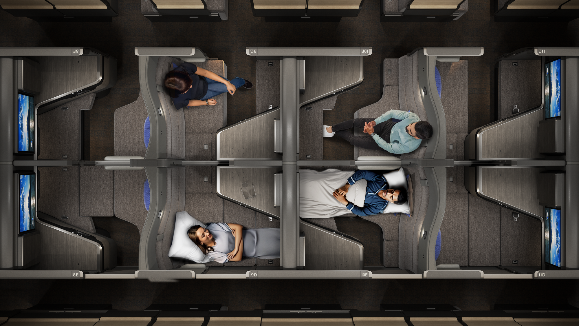 Interior, business class cabin, overhead view: the forwards-backwards layout with overlapping foot areas and tables is shown.