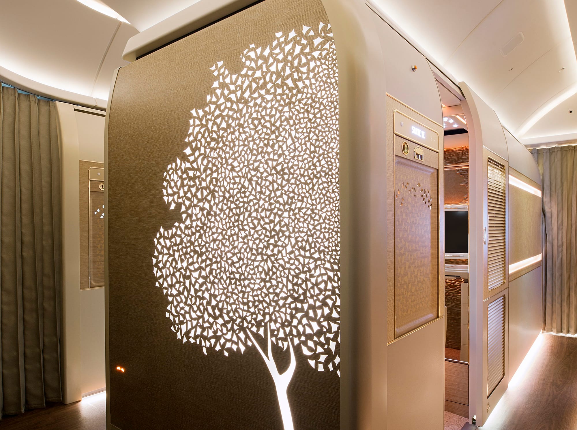 Interior, Emirates 777-300ER "game changer" first class cabin. Looking at the centre suite with a ghat tree backlit pattern on the monument wall.