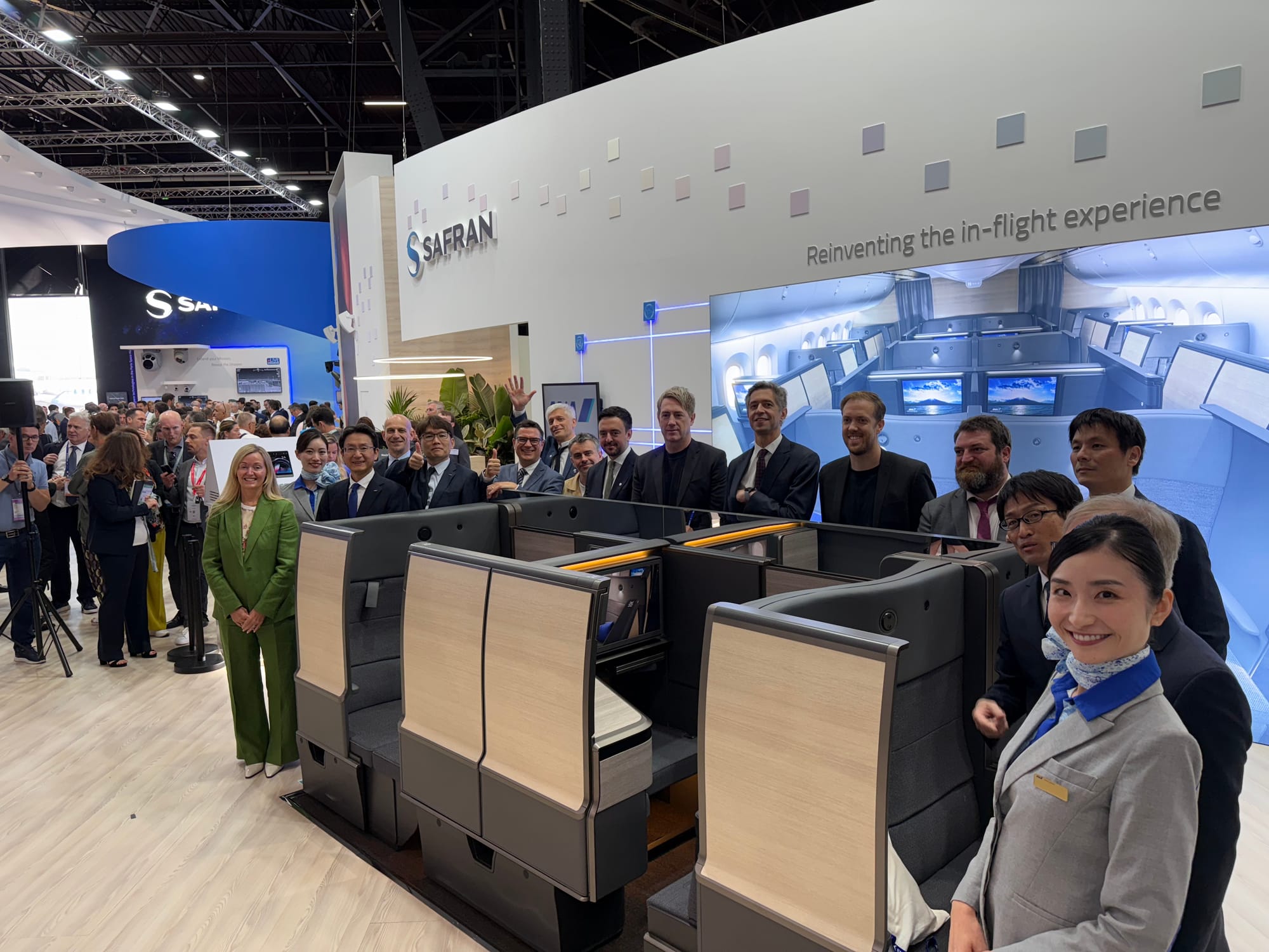 A collection of ANA, Safran and Acumen staff smiling around the new seat.