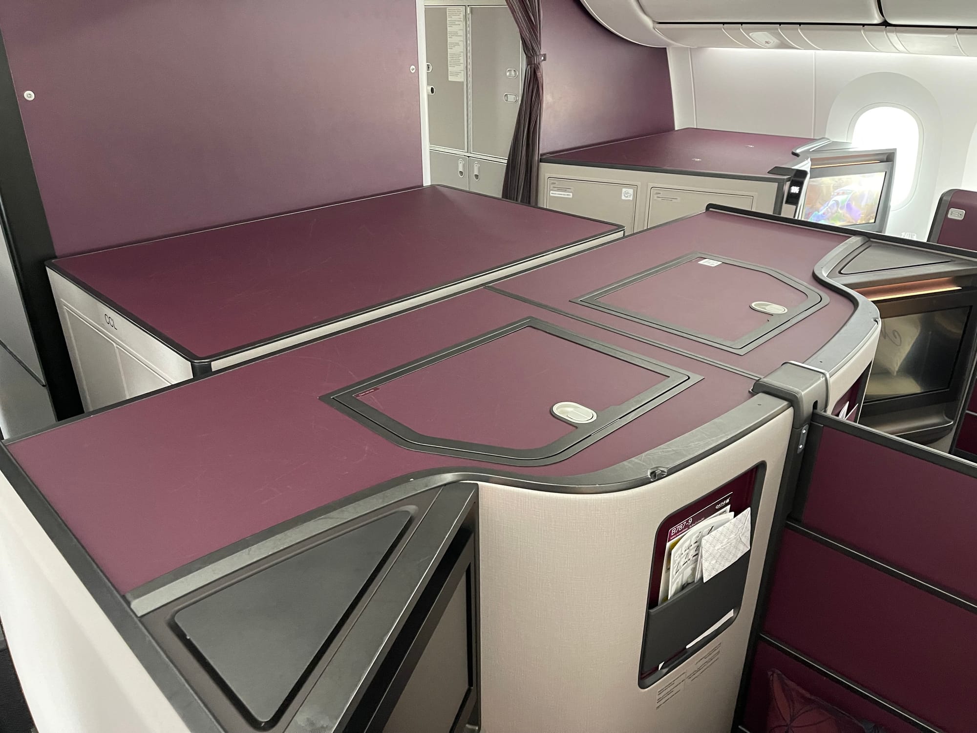 Interior, Boeing 787. A substantial filler section of between 1–2m (3-6 feet) sits ahead of the front row of business class in a hybrid herringbone configuration.