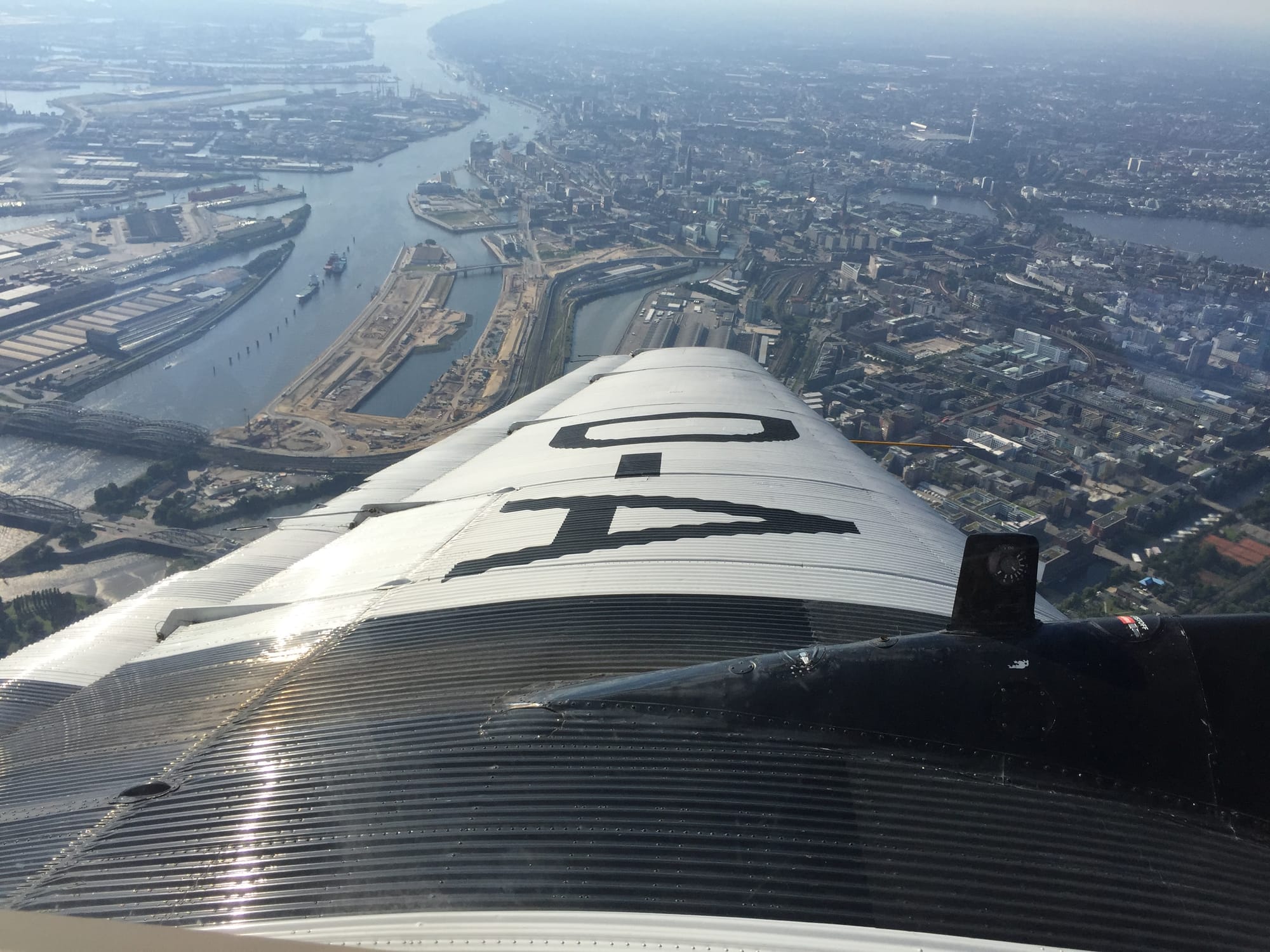 Banking shot over the left wing over the north side of the Elbe with the city centre above