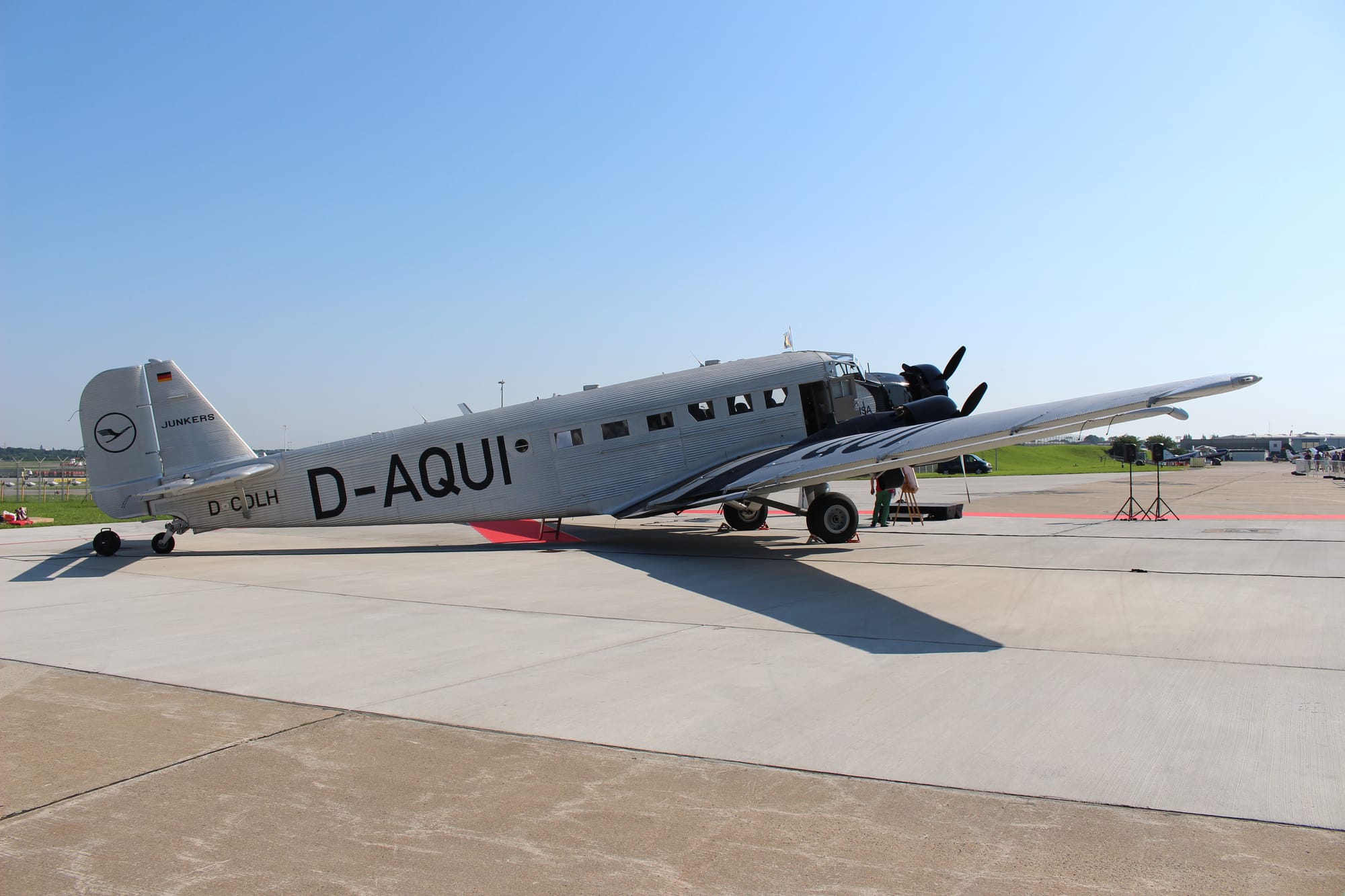 Wide shot of the Ju 52 from the rear right quarter, showing both the large D-AQUI and smaller D-CDLH registrations.