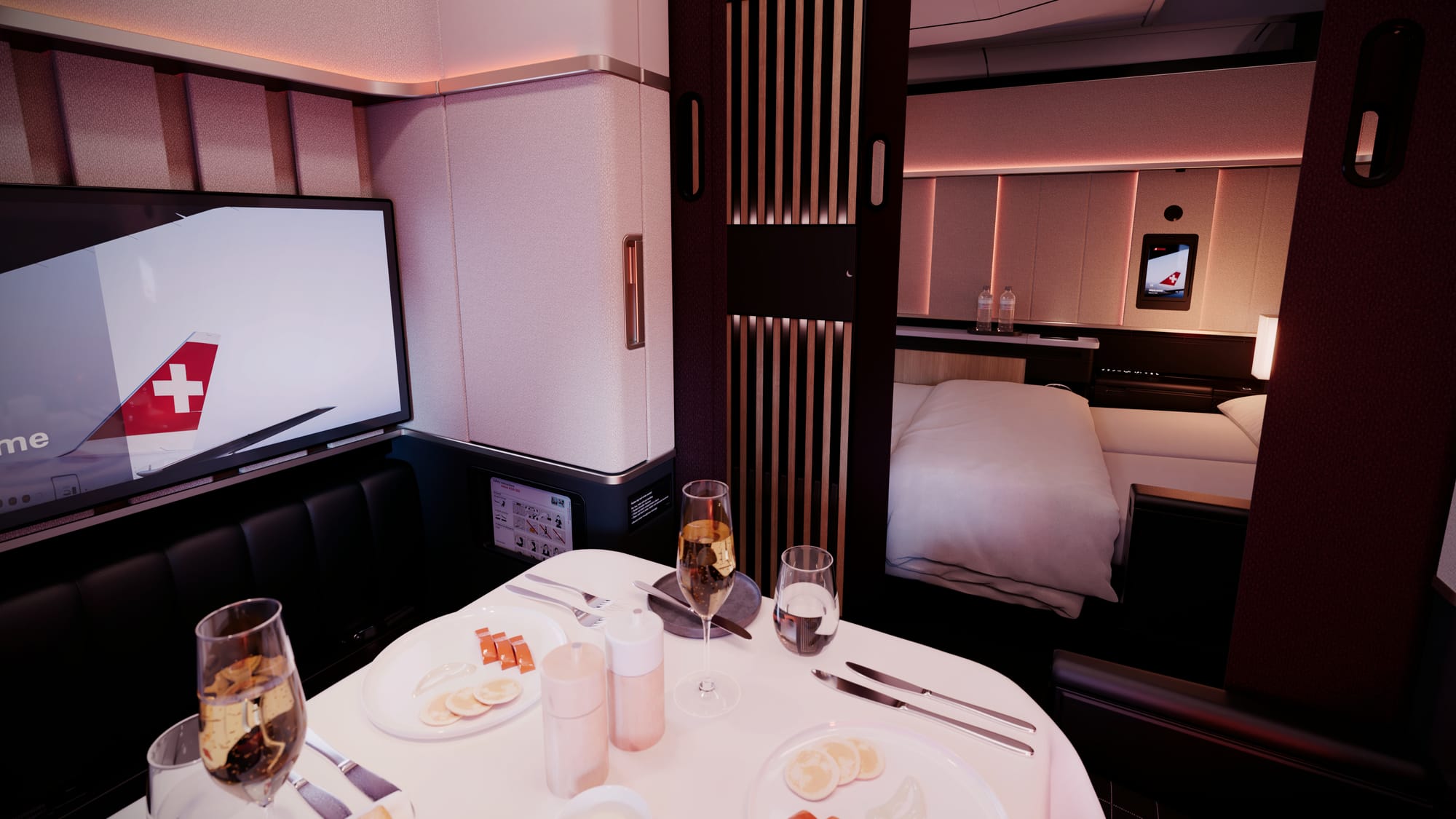 Interior rendering, Swiss first class, FICE generation, A350. Looking from the window suite with its set dining table for two across the aisle to the centre suite set for bed. The aesthetic is dark reds and neutrals.