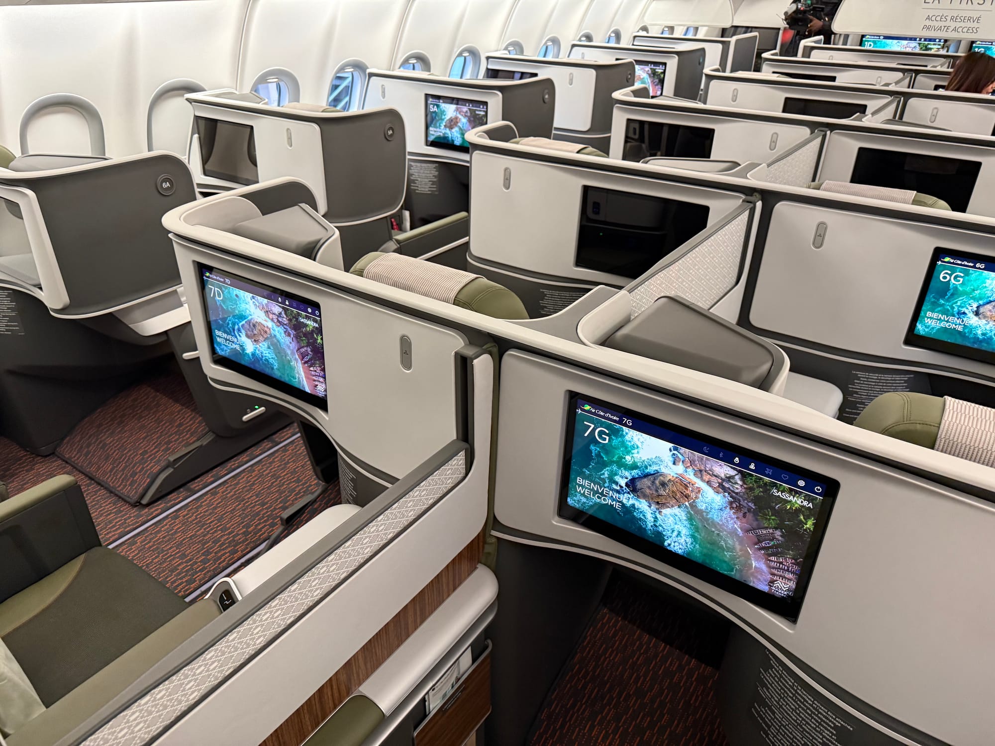 Wide shot of the first business cabin, showing the seats and some of the wood trim around the centre divider.
