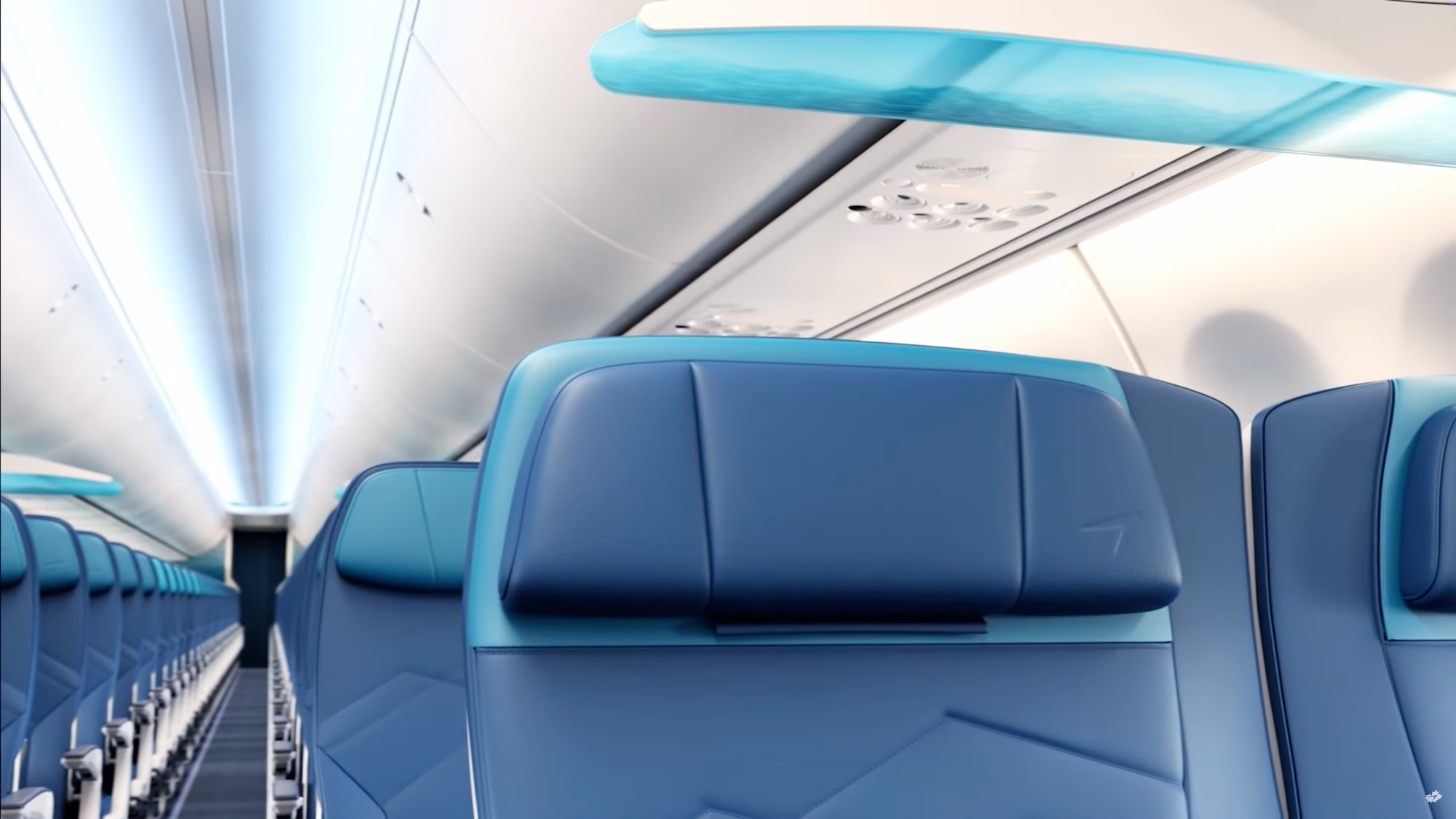 Interior, 737. Looking down the aisle from the last seat of recliners (with an overhead translucent divider). The seats are all in blue and turquoise.