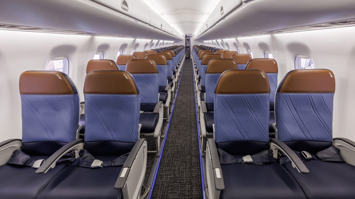 Interior, E170/175, 2-2 economy section, with brown headrests for extra-legroom economy and dark blue for regular economy.