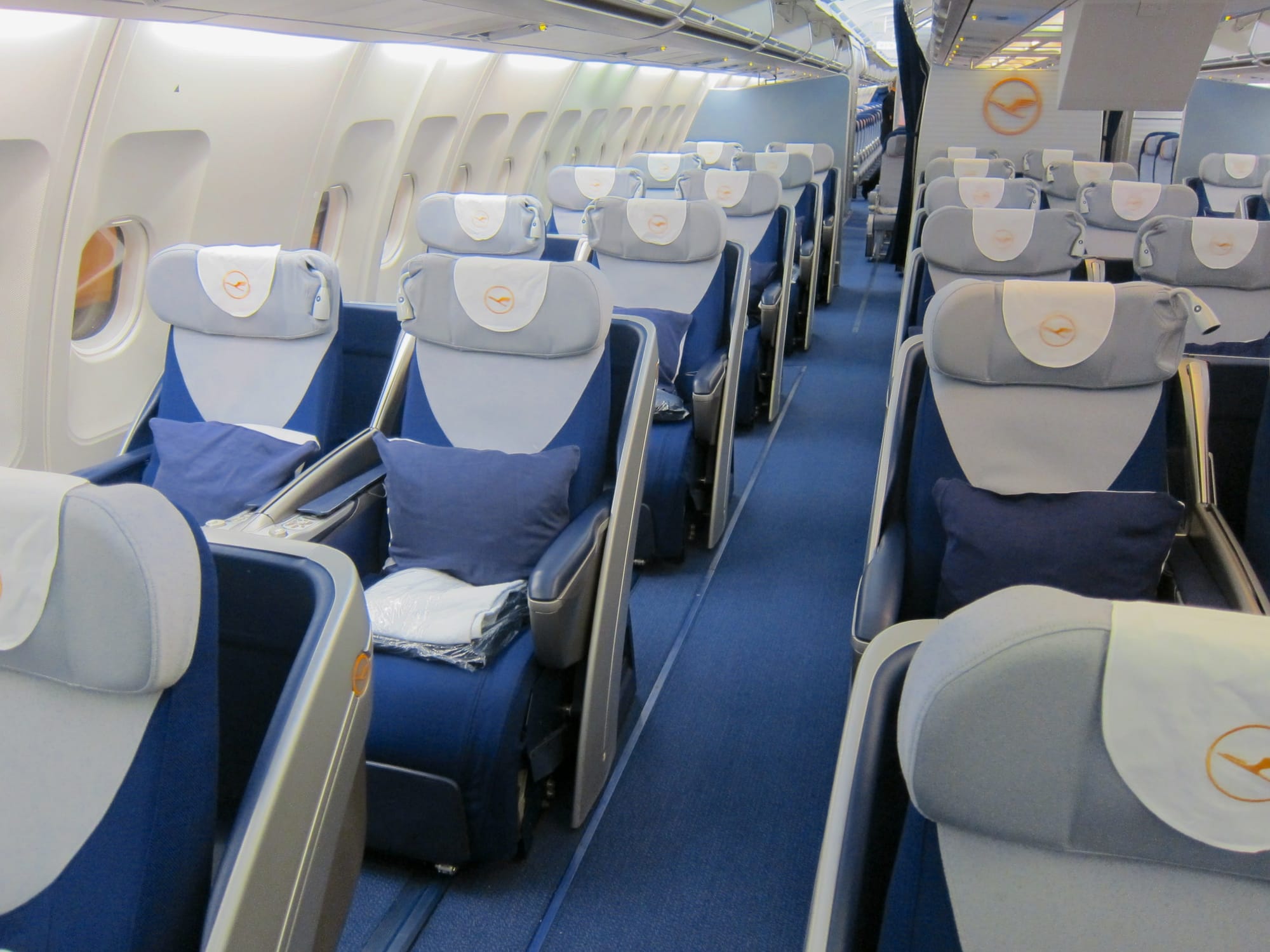 Interior, business class cabin, A340, 2-2-2 angled lie-flat seats in blue and white with a little grey.