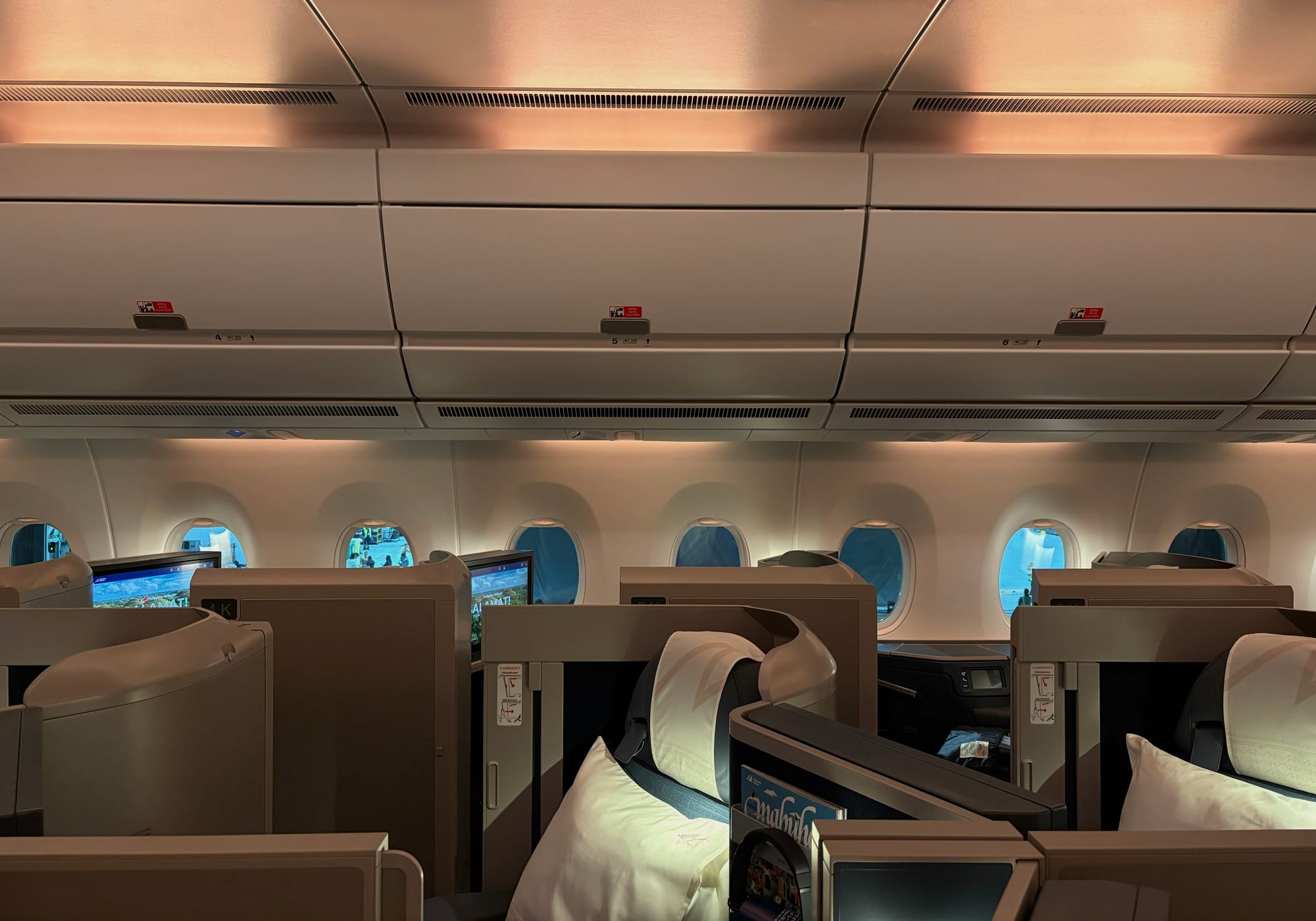 Looking sideways in the business cabin, with pooling sidewall lighting that breaks up the sidewalls and ceilings visually.