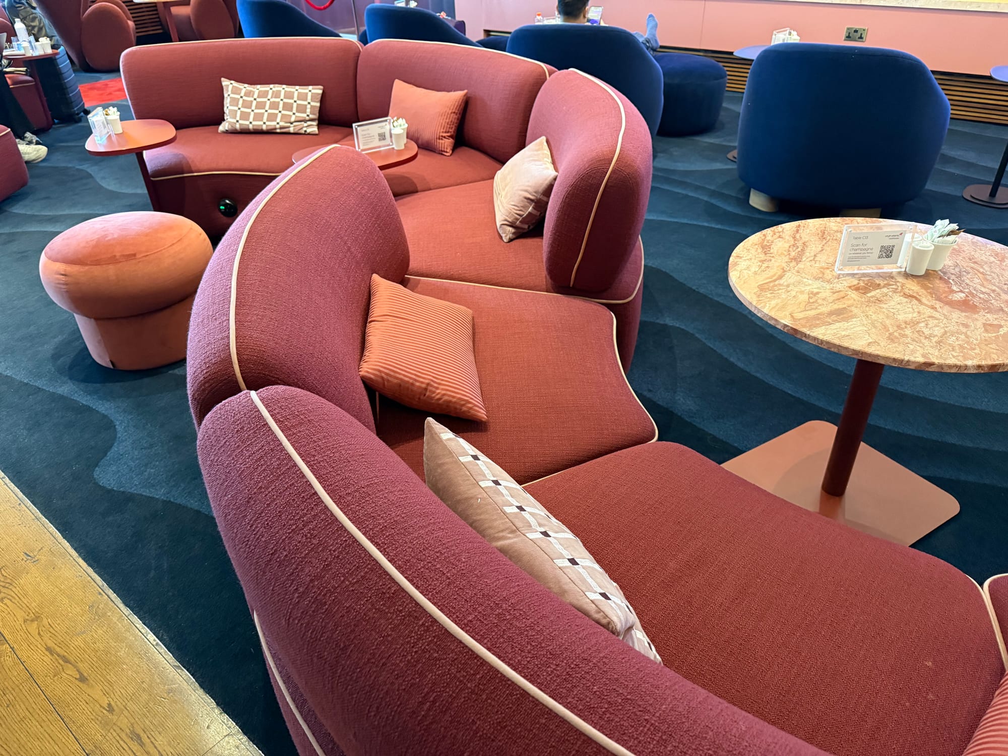 Close-up on those red sofas, with a green light glowing on one of them where a power socket will be.