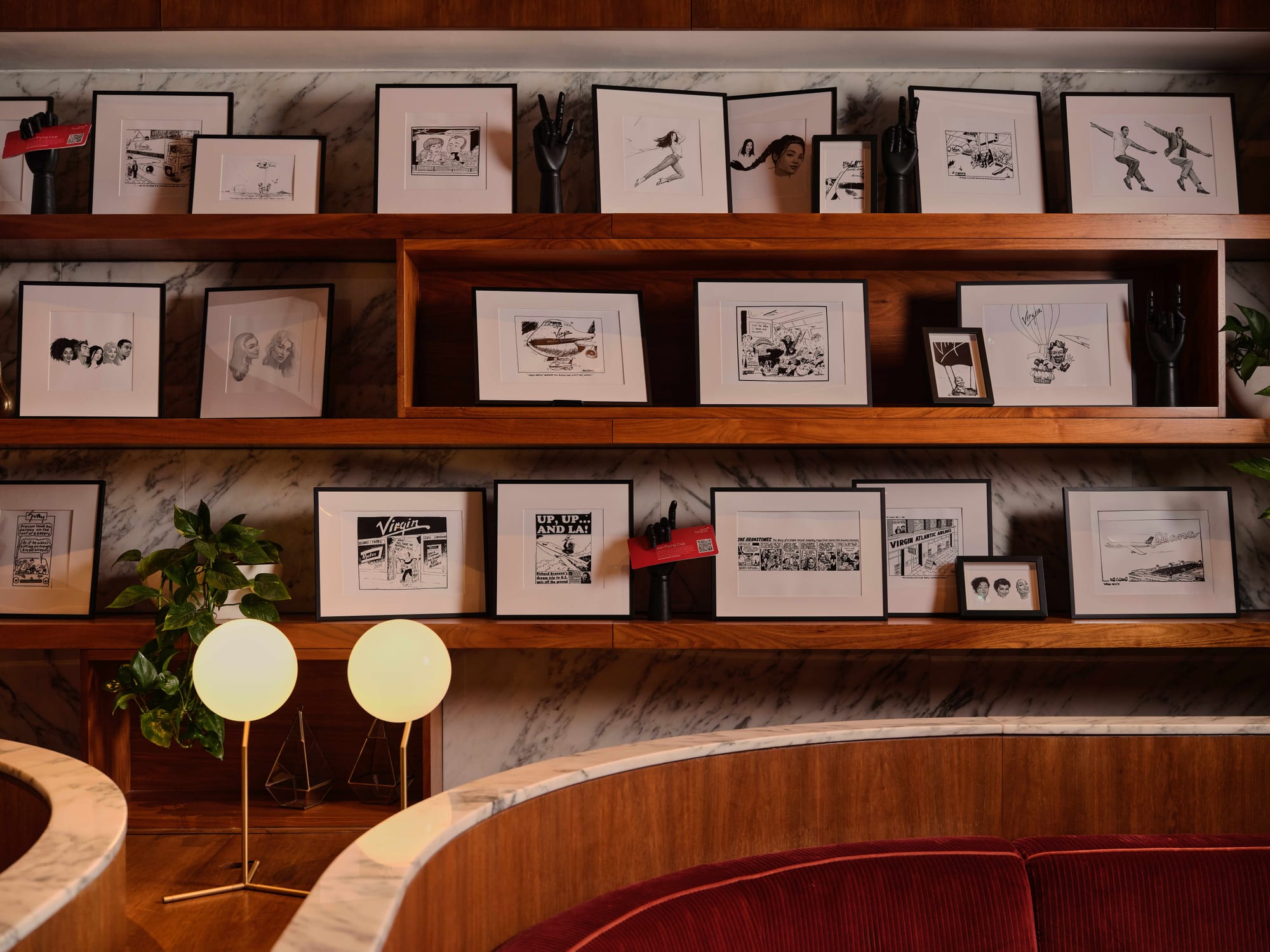 PR shot, showing a couple dozen black-and-white cartoons, caricatures and early sketches for flying lady pinup mascots.