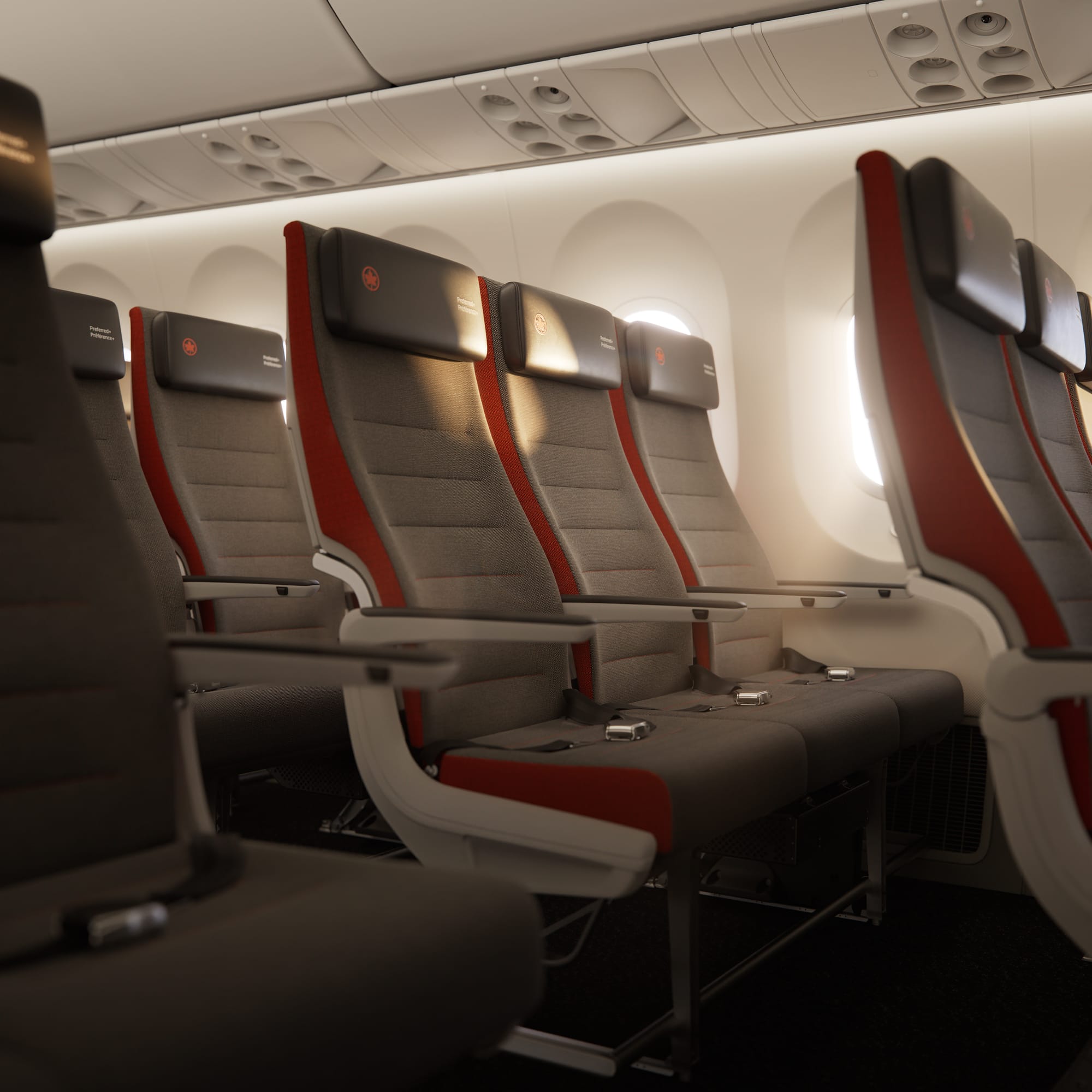 A pop of red along the side of the economy seats marked “Preferred+” in a 787 cabin.