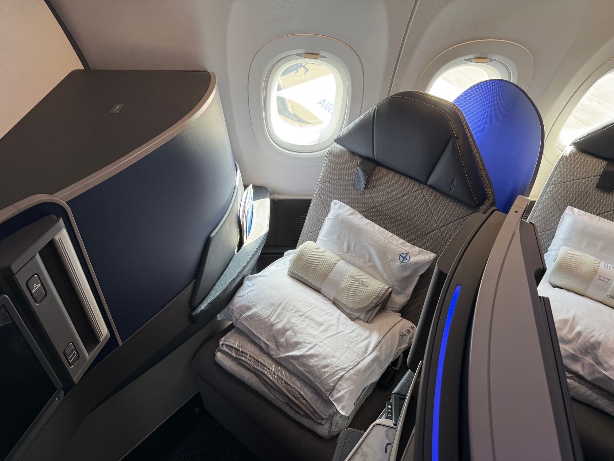 The same business class seat, but the 1K seat, with a monument approximately 60-75cm wide replicating the shape of the other seats rather than being a larger space.
