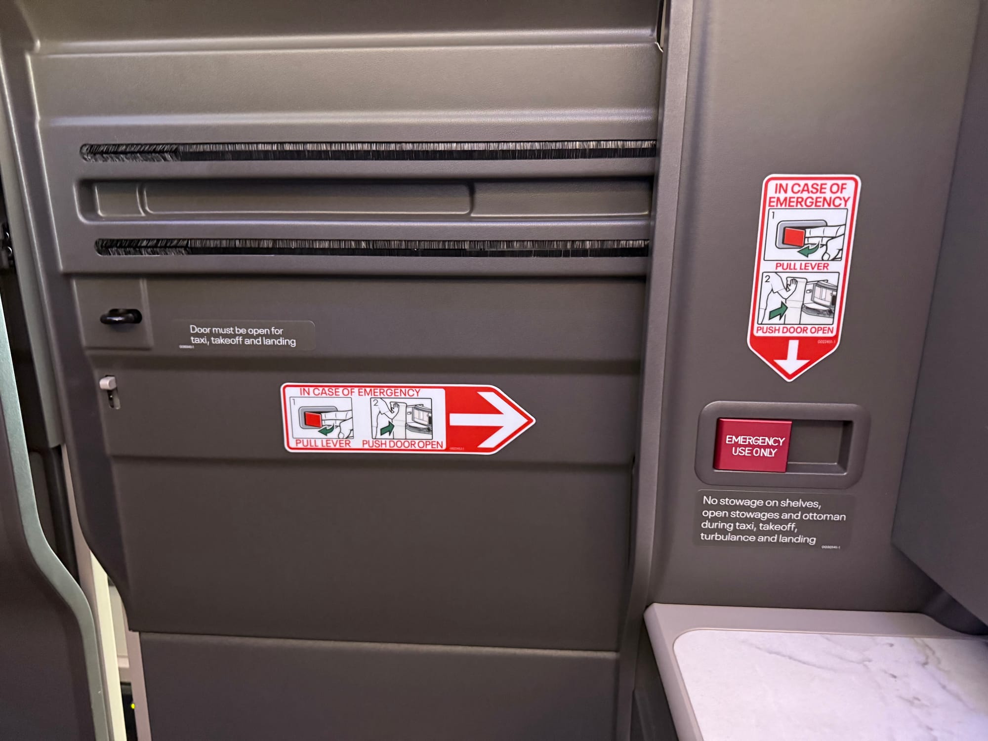 The closed door, which looks very raw and unfinished, with many different levels of plastic and an emergency release function.