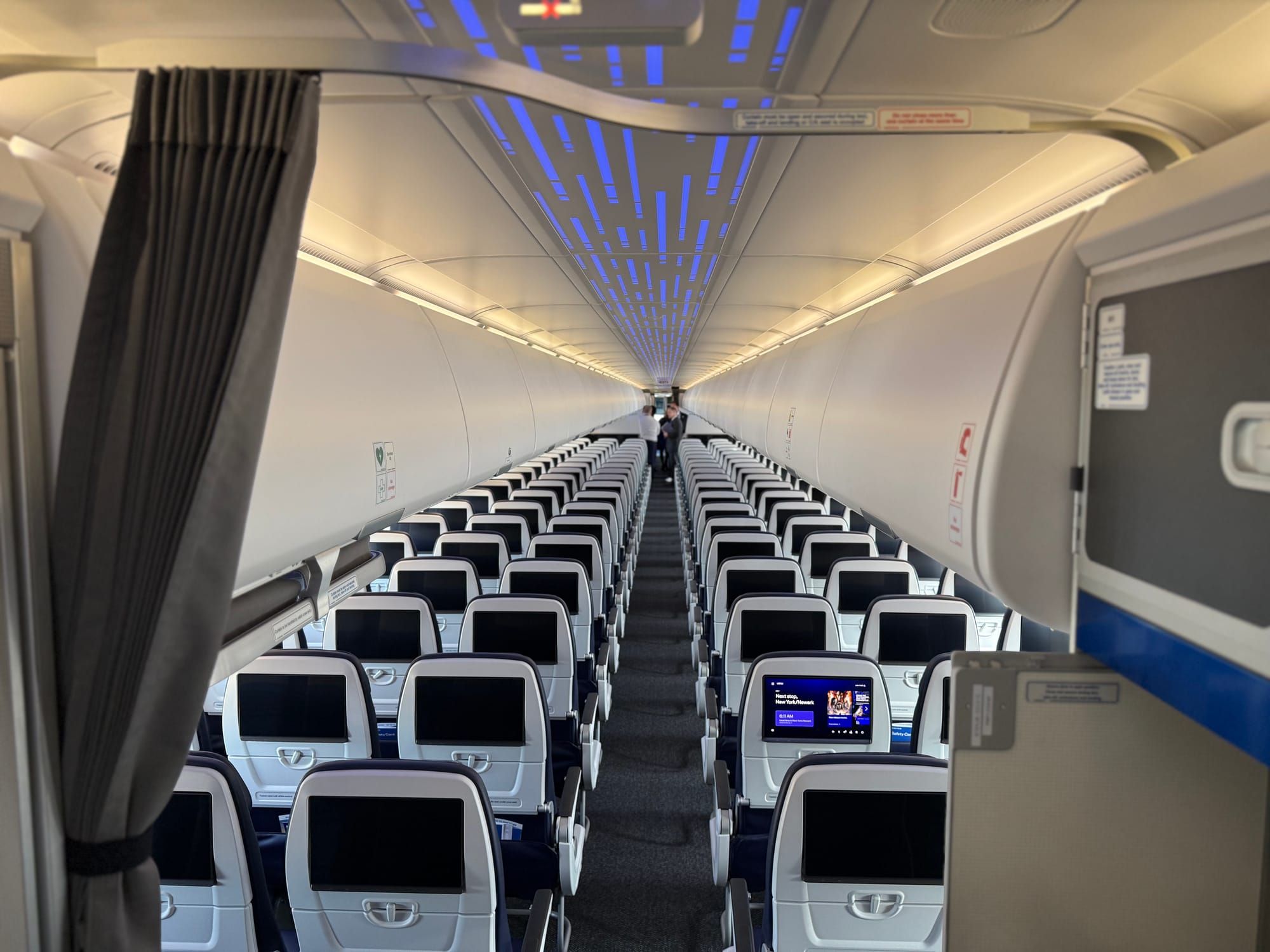 Looking forward from the rear of the XLR aisle, seeing only economy class seats roughly halfway up the aircraft.