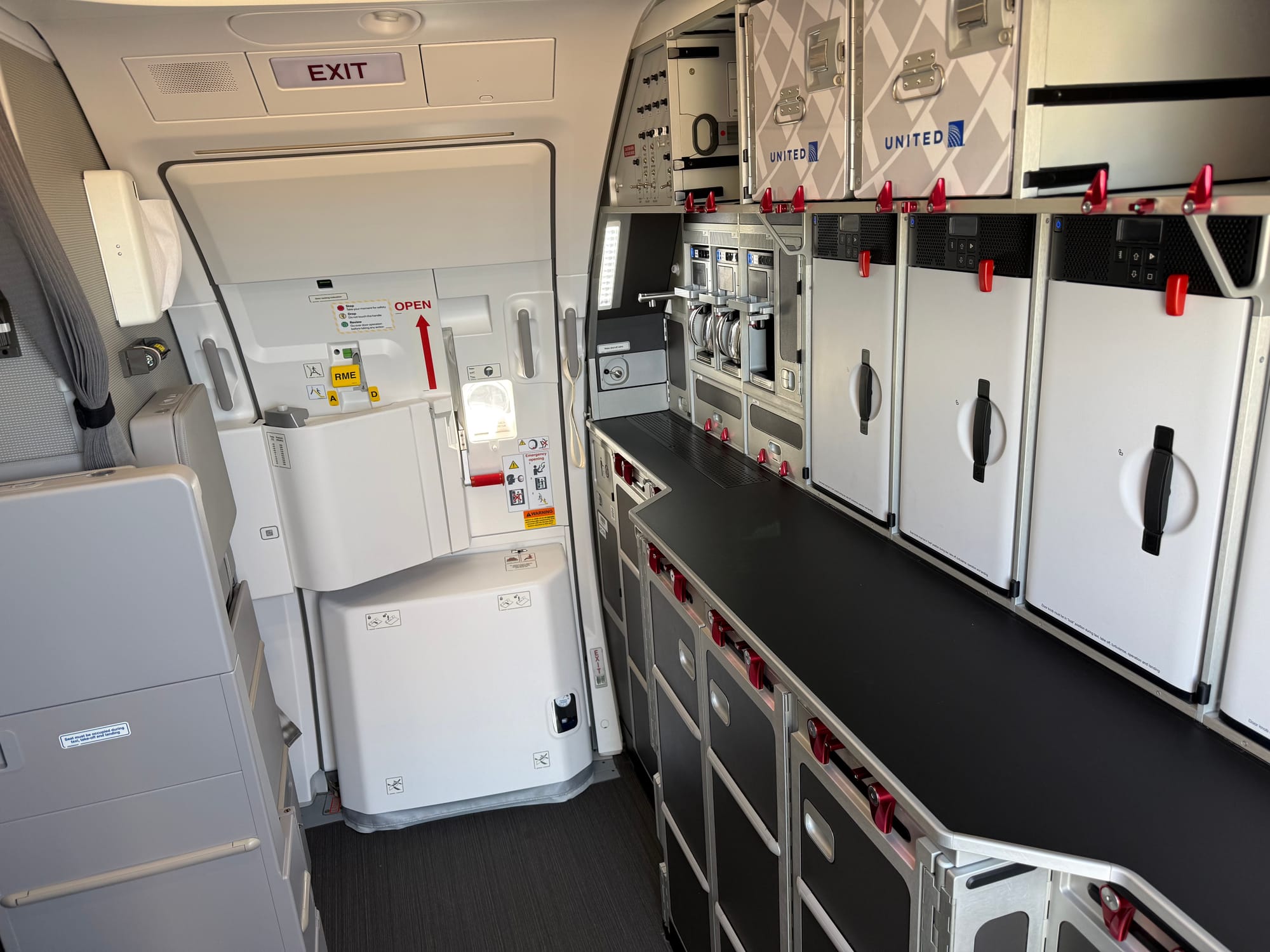 A full-width rear A320 family galley, with a bumpout for the rear surface, with trolleys underneath.