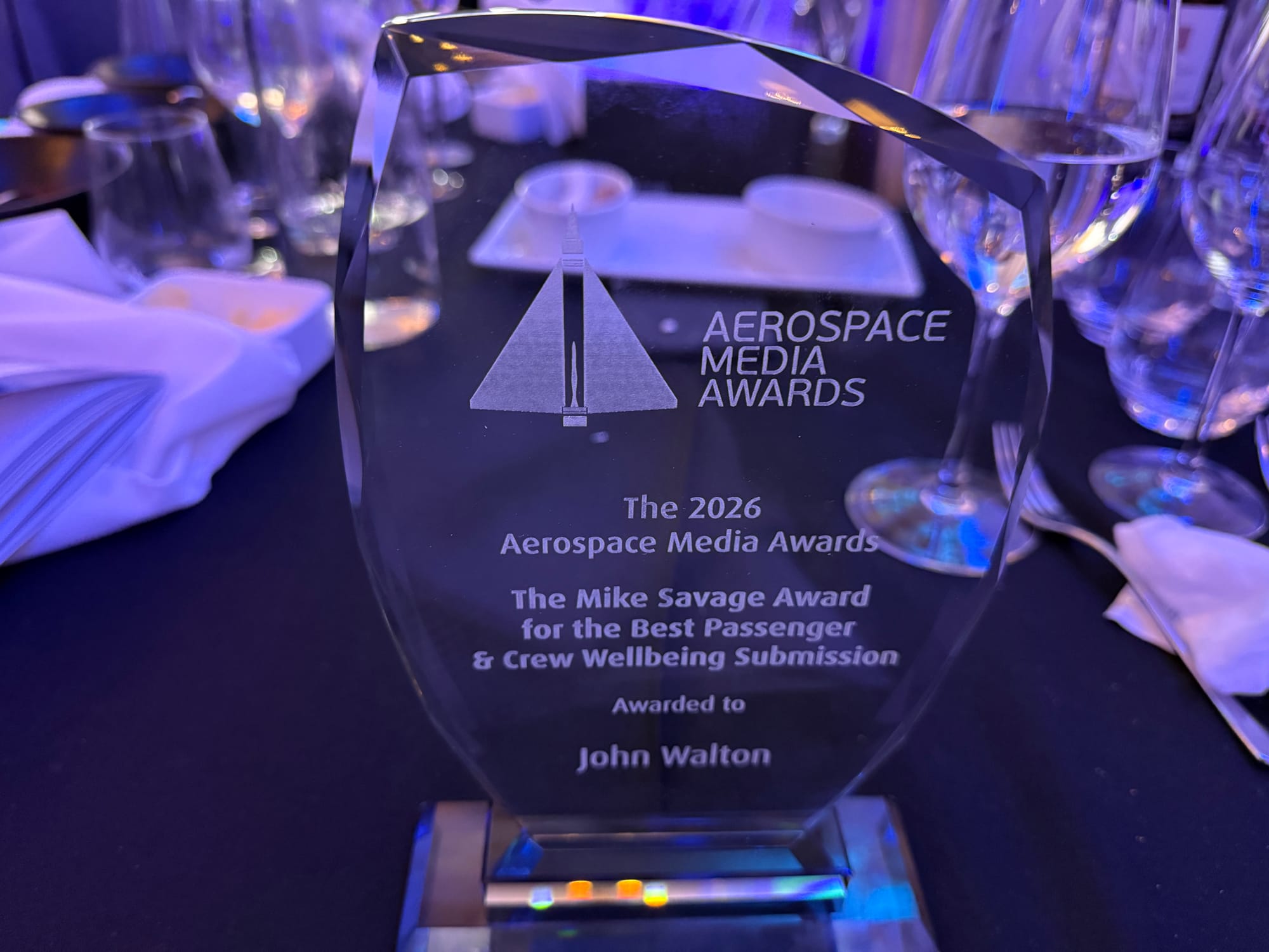 A glass award: The 2026 Aerospace Media Awards. The Mike Savage Award for the Best Passenger & Crew Wellbeing Submission Awarded to John Walton