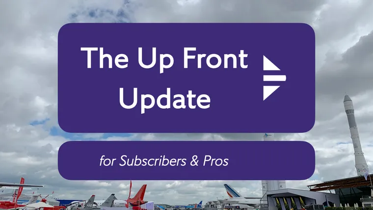 A wide shot of the Paris Air Show grounds, with airplanes and rockets at Le Bourget, plus the Update logo