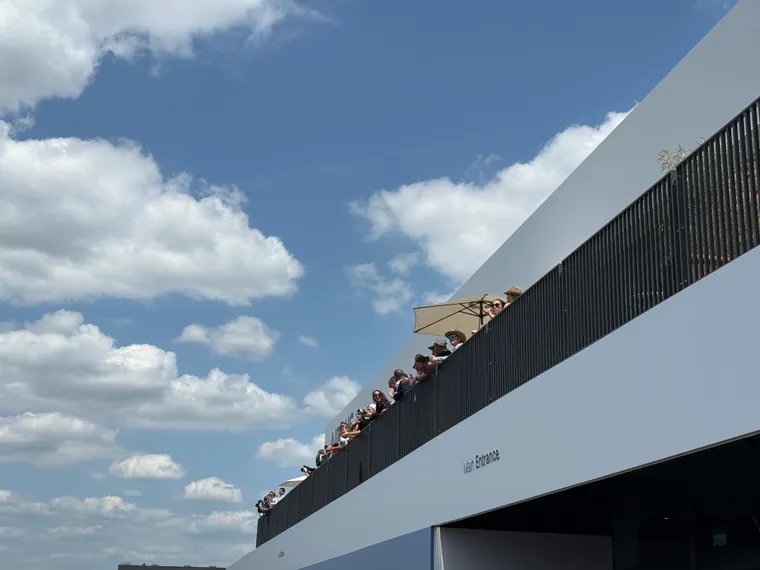 People taking pictures off the top of a chalet at the Paris Air Show