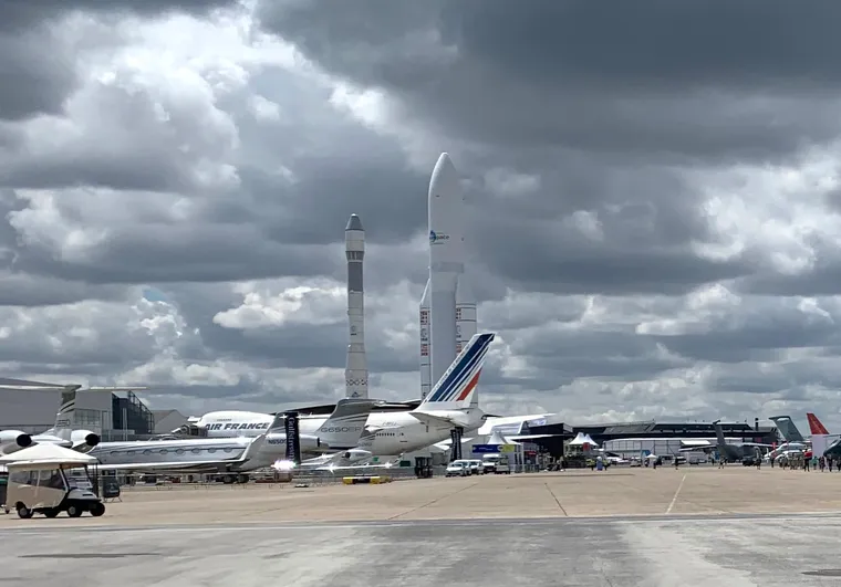 A wide shot of the Paris Air Show grounds, with airplanes and rockets at Le Bourget