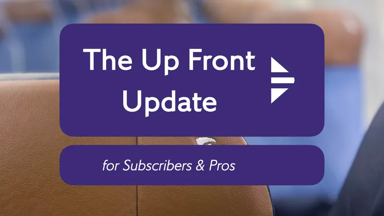 A closeup shot on a brown headrest with blue seats and brown headrests beyond, with the Update logo.