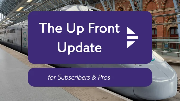 A grey double decker TGV in St Pancras, with the Update logo on top