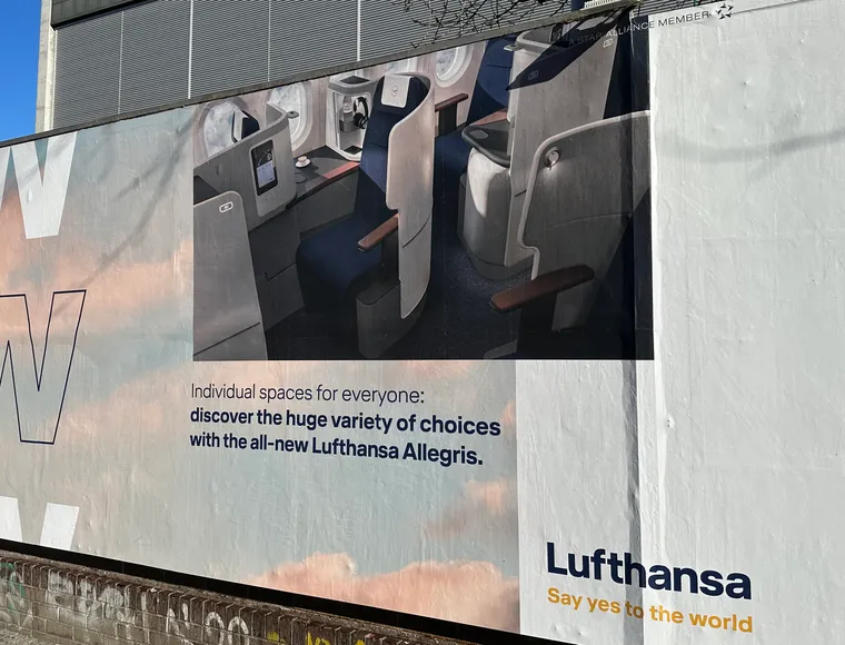 A billboard outside Lufthansa's Allegris launch with the business cabin and "Individual spaces for everyone: discover the huge variety of choices with the all-new Lufthansa Allegris"
