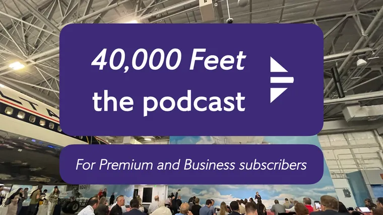 People gathered around tables in a hangar with a large Delta airplane above them.