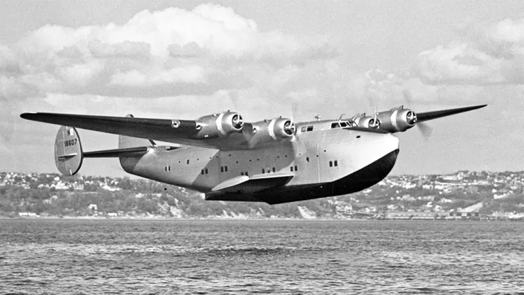 large four engined seaplane just above the water