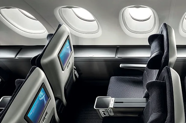 BA premium economy seats in grey and blue on the upper deck of an A380, with side bins.