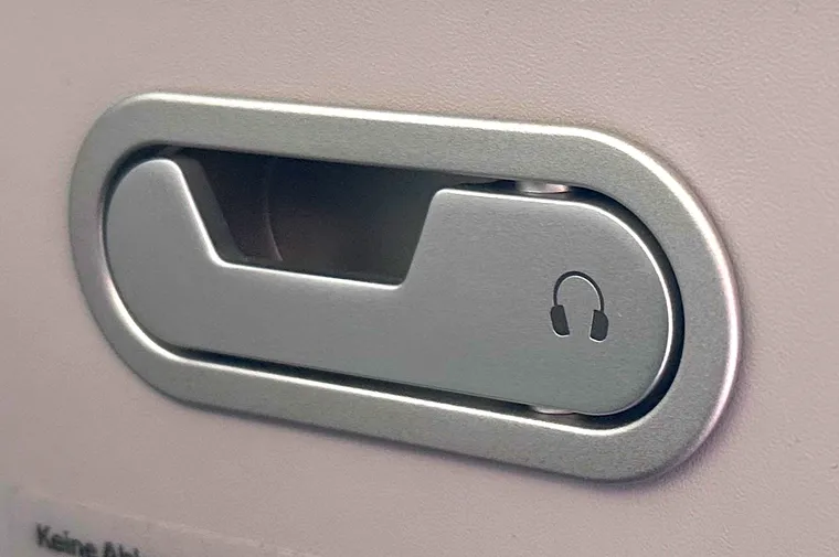 Close-up on a headphone holder from a business class seat