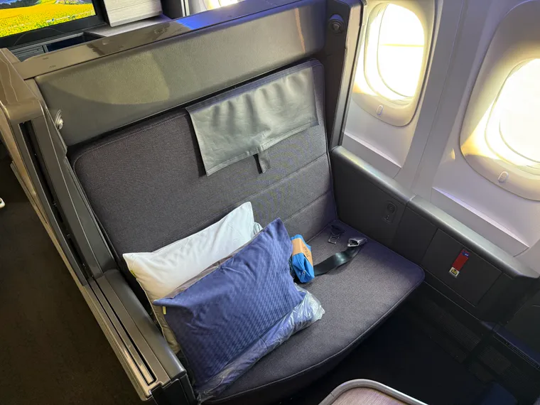 Interior, 777. ANA’s The Room business class seat: wide, dark greys and blues, spacious.