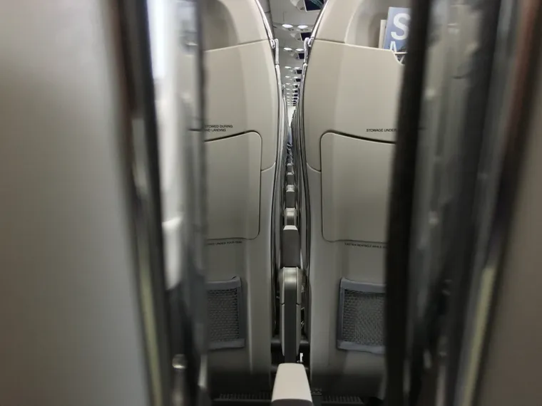 A shot through the seat gaps on an A220, at around tray table level.