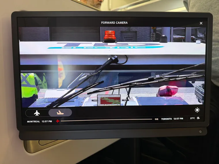 Closeup on an inflight entertainment screen in business class, showing a 4K view out the front of the airplane