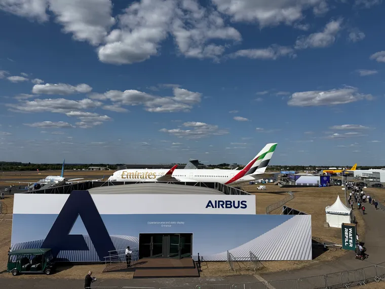 Farnborough flightline, very sparse: an A321neo, an A350-900, and a 777 converted freighter in the distance
