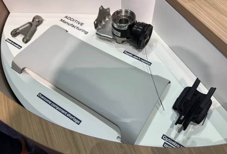 Several additively manufactured items on display, including plastics, metals and components
