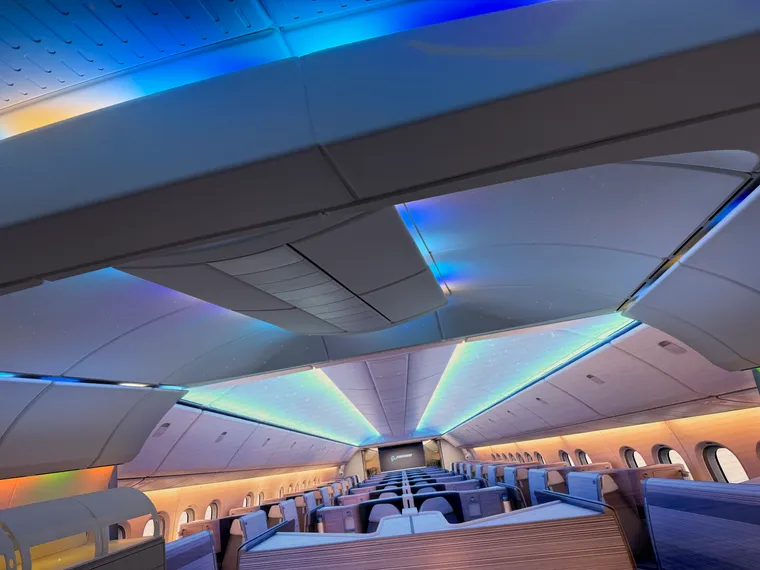 Interior, Boeing 777X mockup cabin, with big screen extending the cabin from doors 1 across a hybrid herringbone cabin of business class.