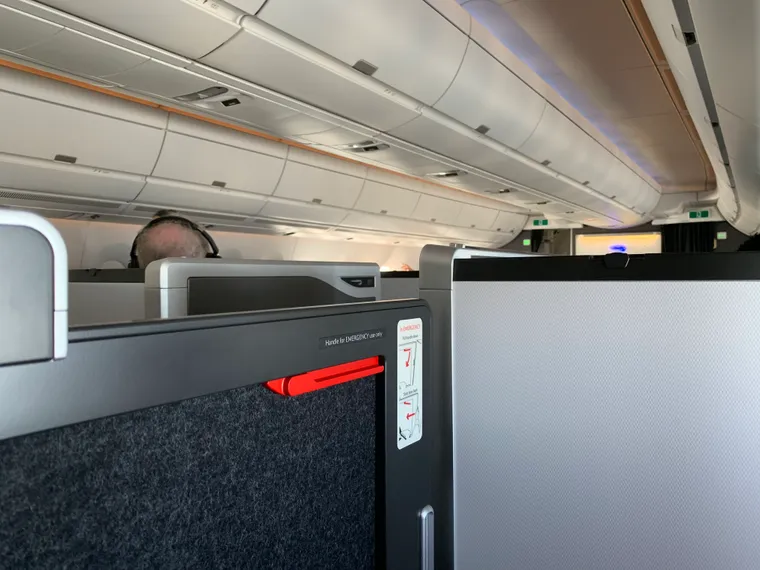 Interior, business class, A350-1000. Looking at the low door of a BA Club Suite, Collins Elevation, with its red handle.