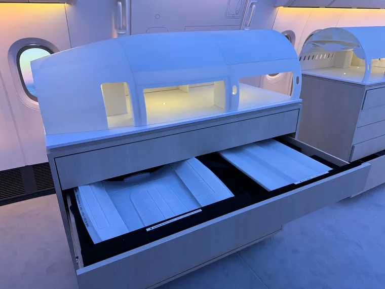 Trade show stand: widebody cabin physical models, with drawers containing overhead bin options